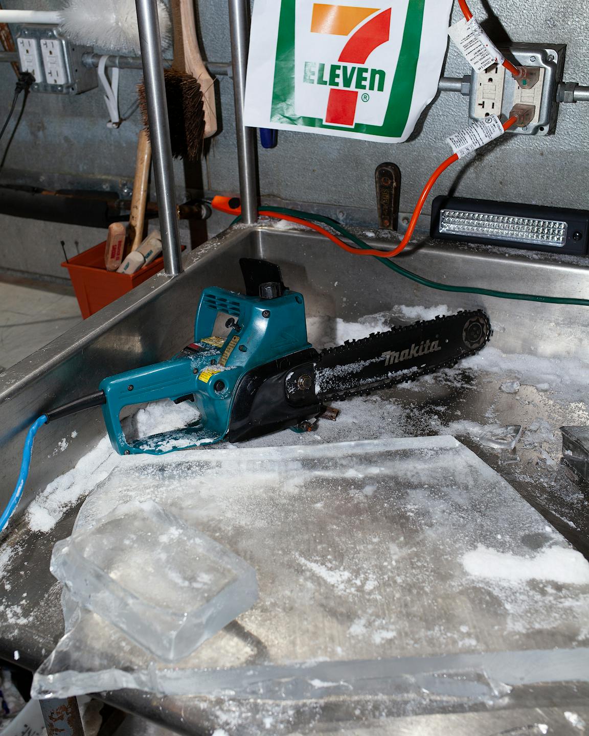 A chainsaw sits atop a block of ice.